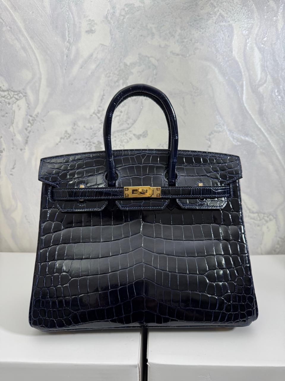 Herm**s crocodile bags.