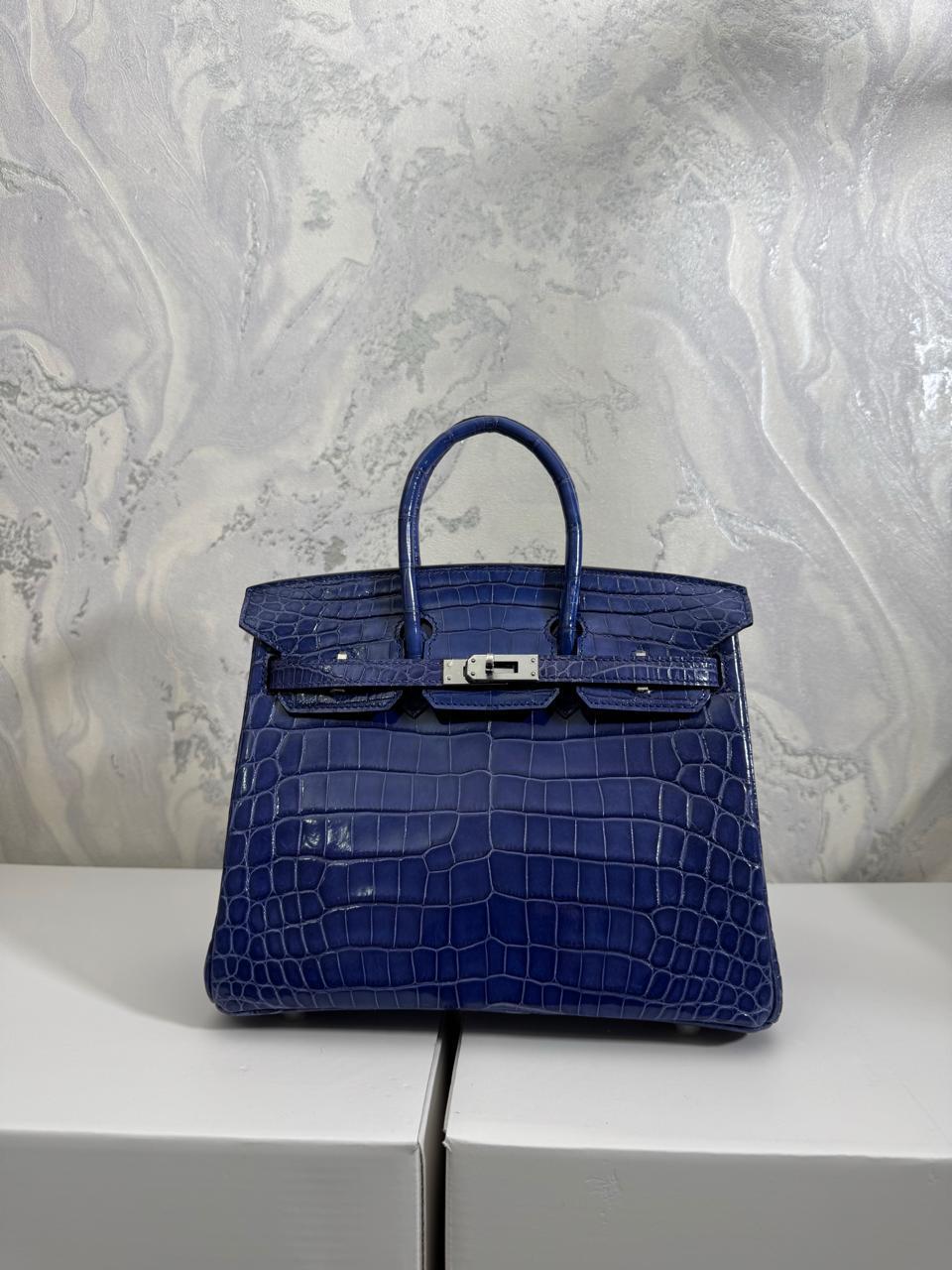 Herm**s crocodile bags.