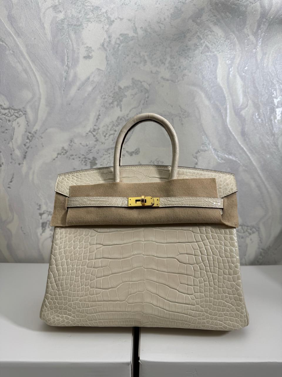 Herm**s crocodile bags.