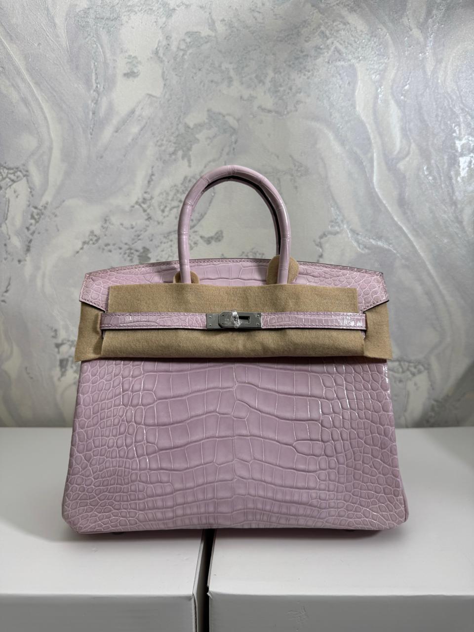 Herm**s crocodile bags.
