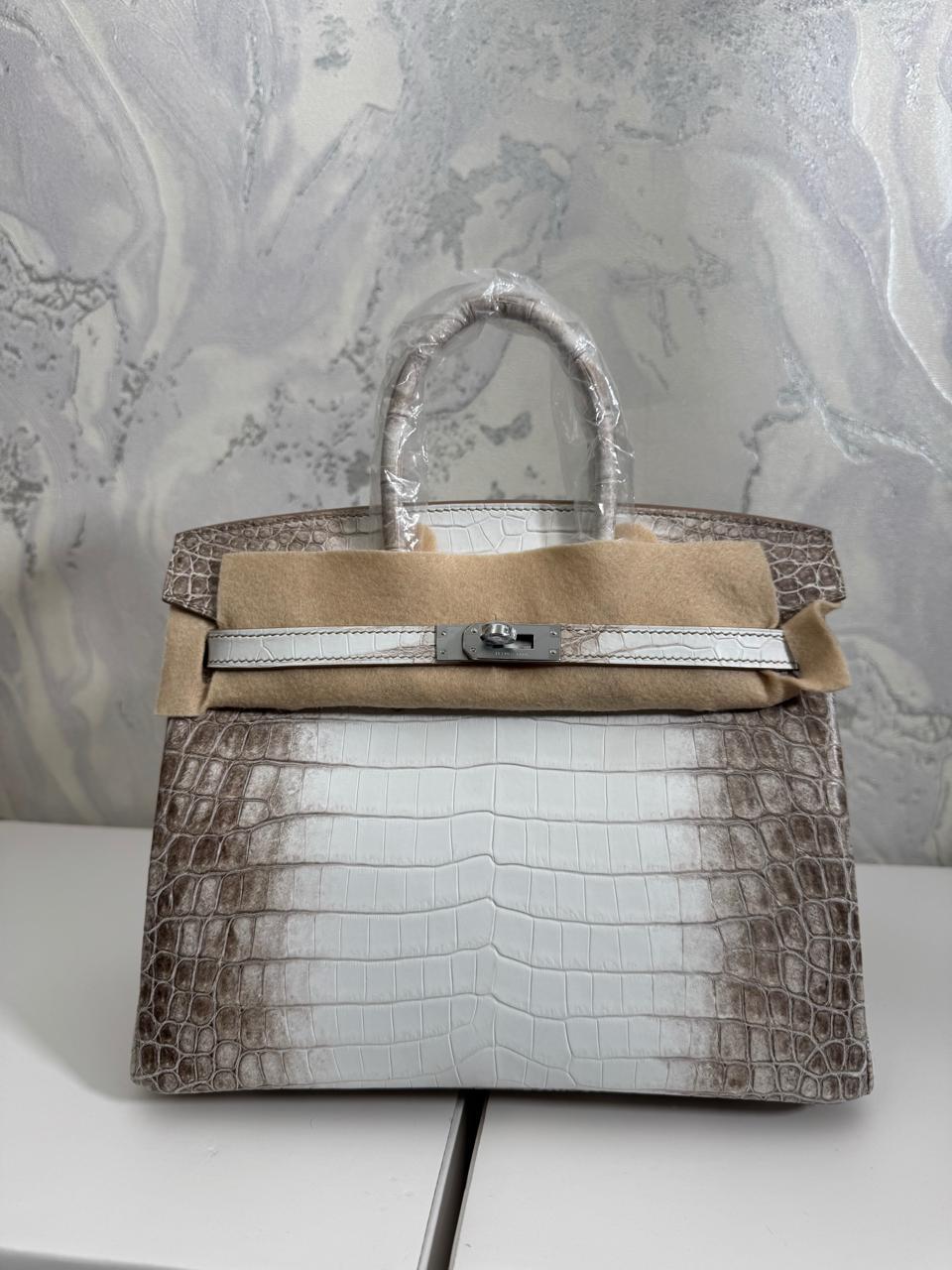 Herm**s crocodile bags.