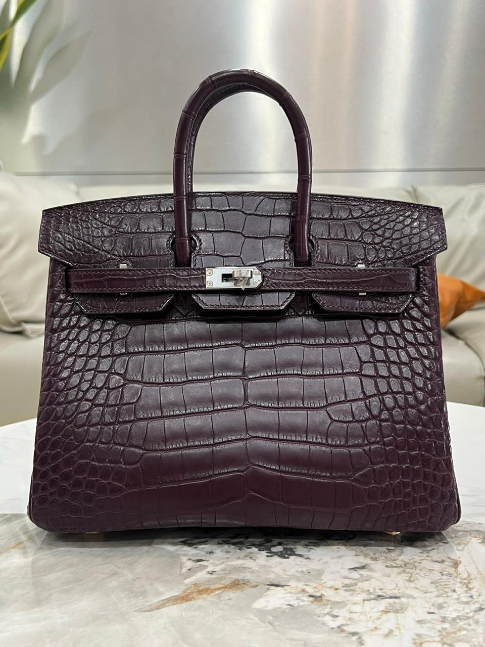 Herm**s crocodile bags.