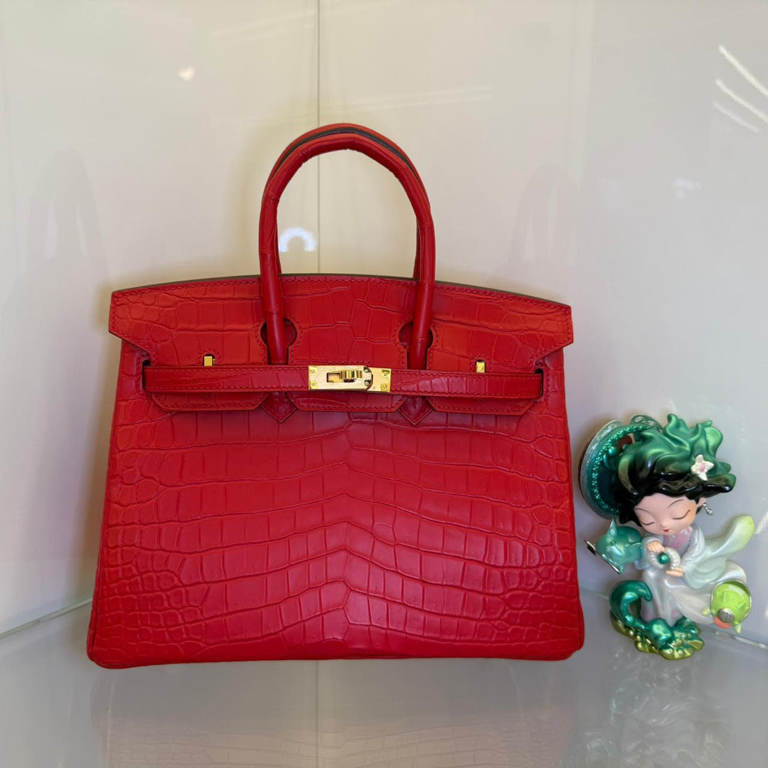 Herm**s crocodile bags.