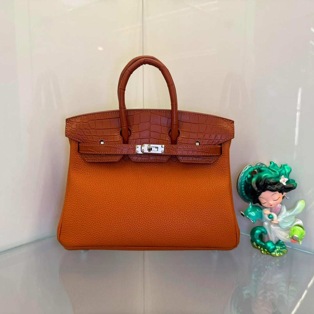 Herm**s crocodile bags.