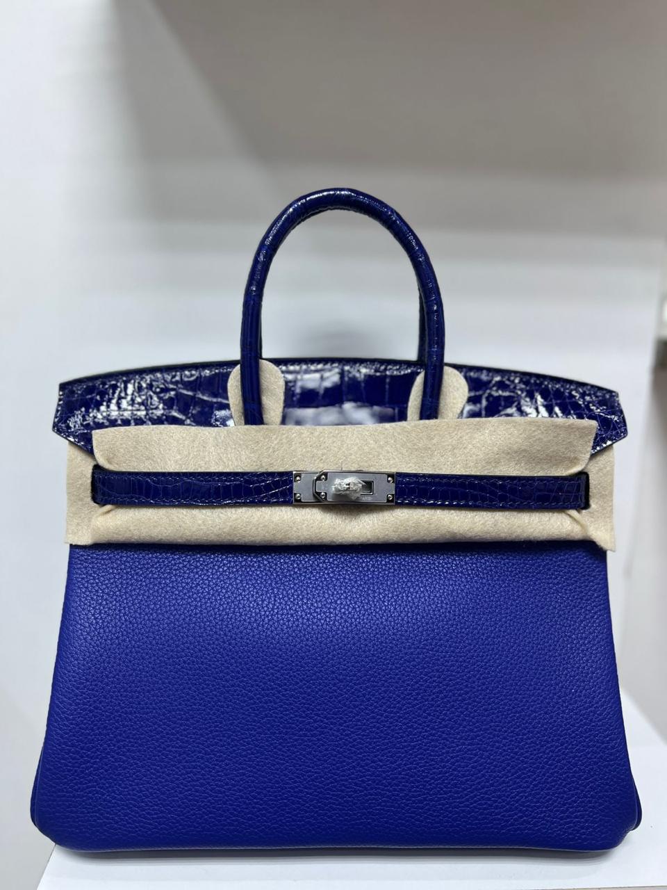 Herm**s crocodile bags.
