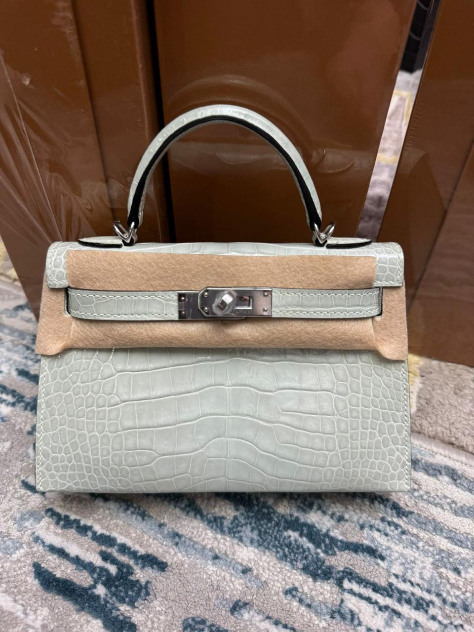 Herm**s crocodile bags.