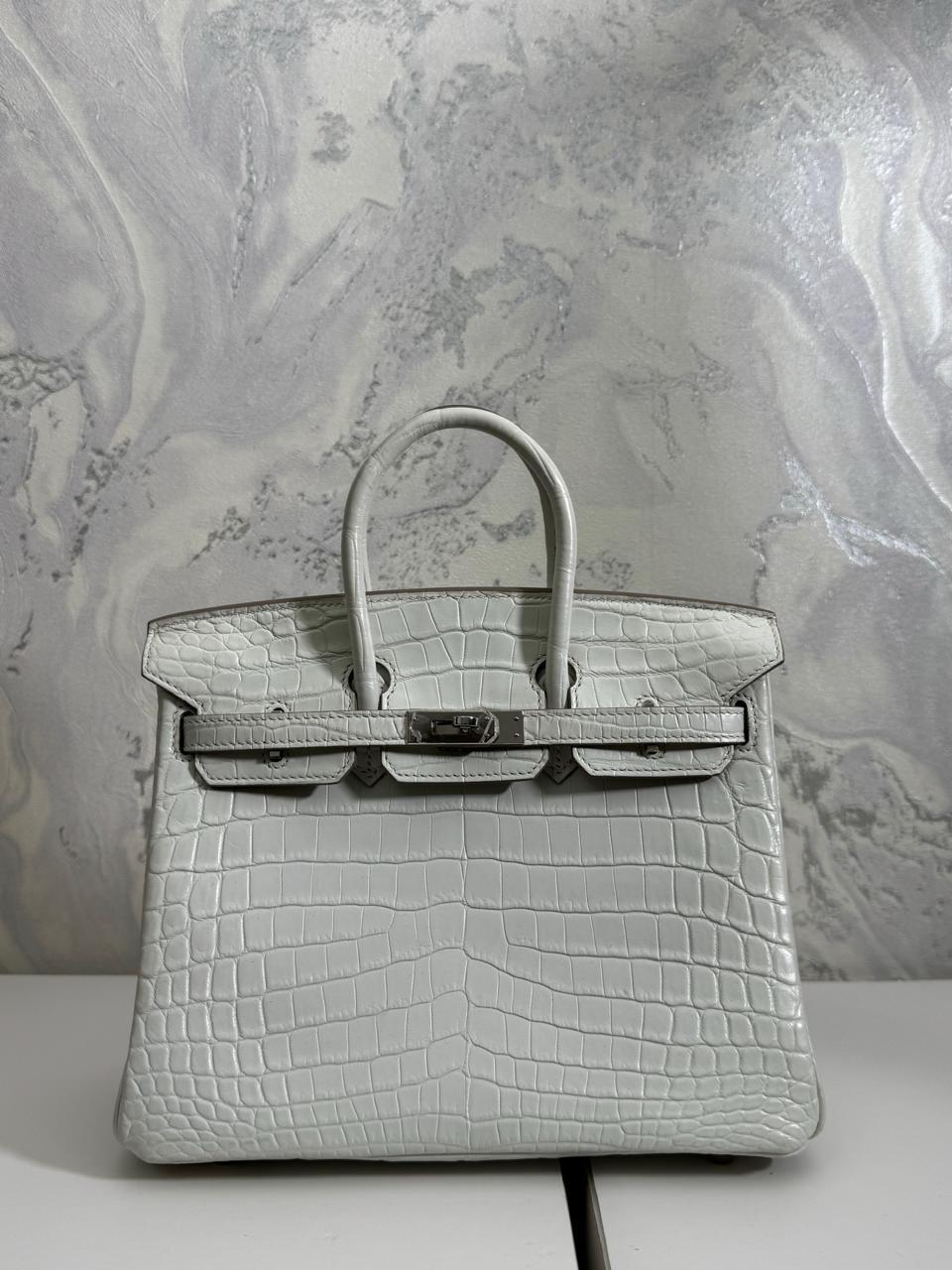 Herm**s crocodile bags.