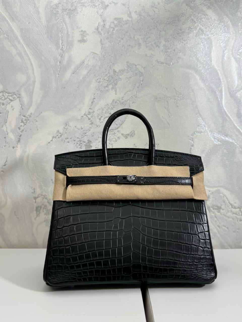 Herm**s crocodile bags.