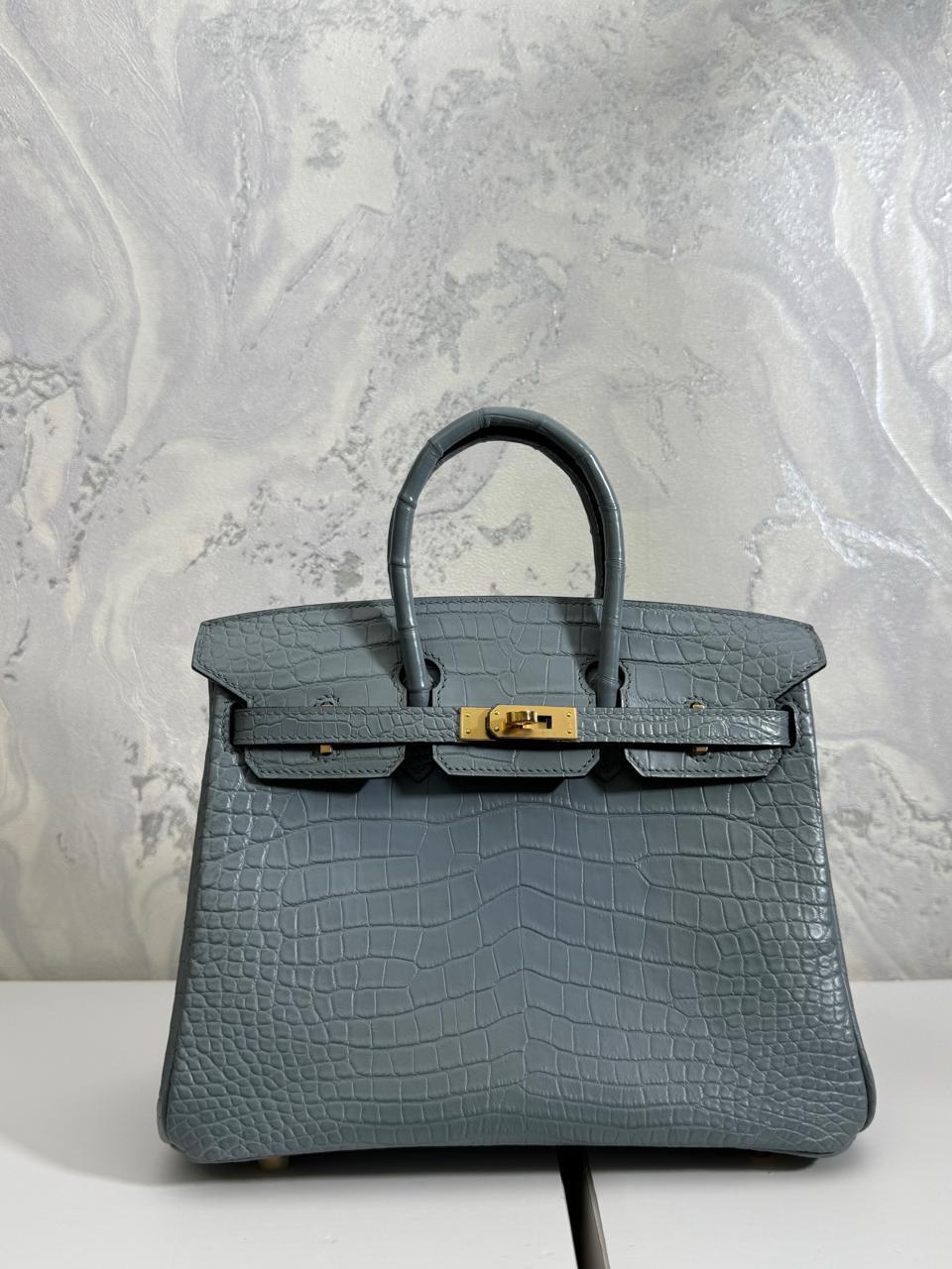 Herm**s crocodile bags.