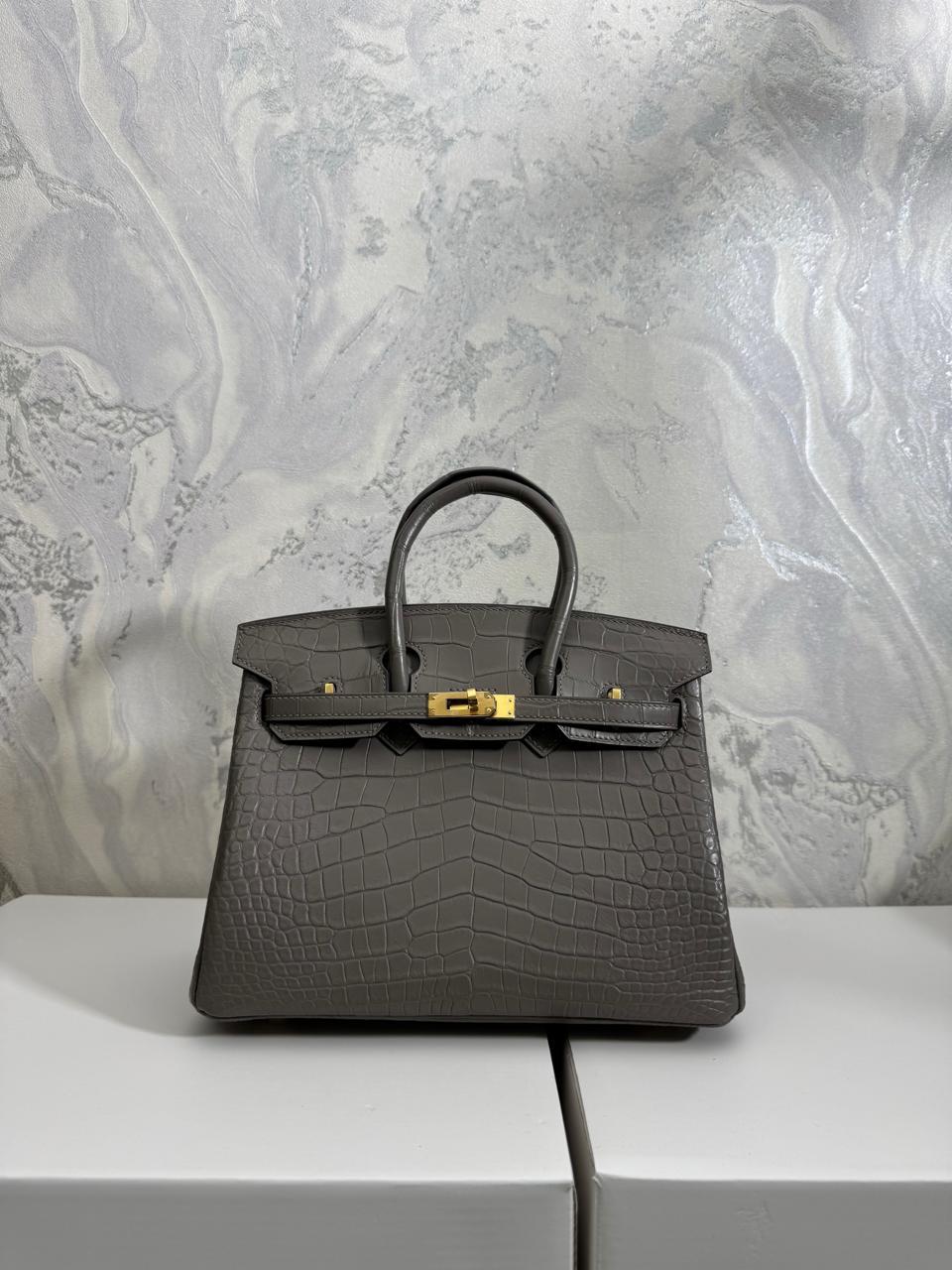 Herm**s crocodile bags.
