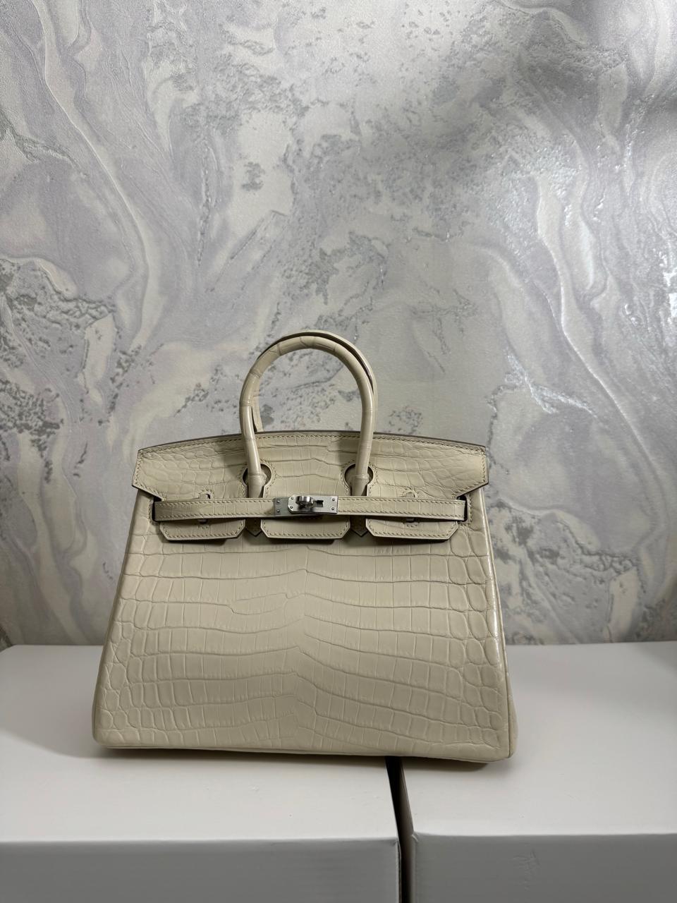 Herm**s crocodile bags.