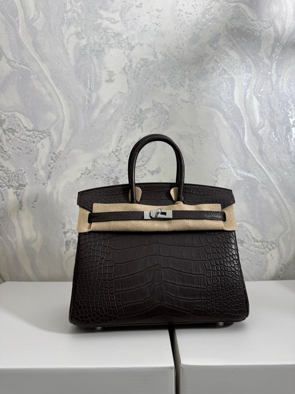 Herm**s crocodile bags.