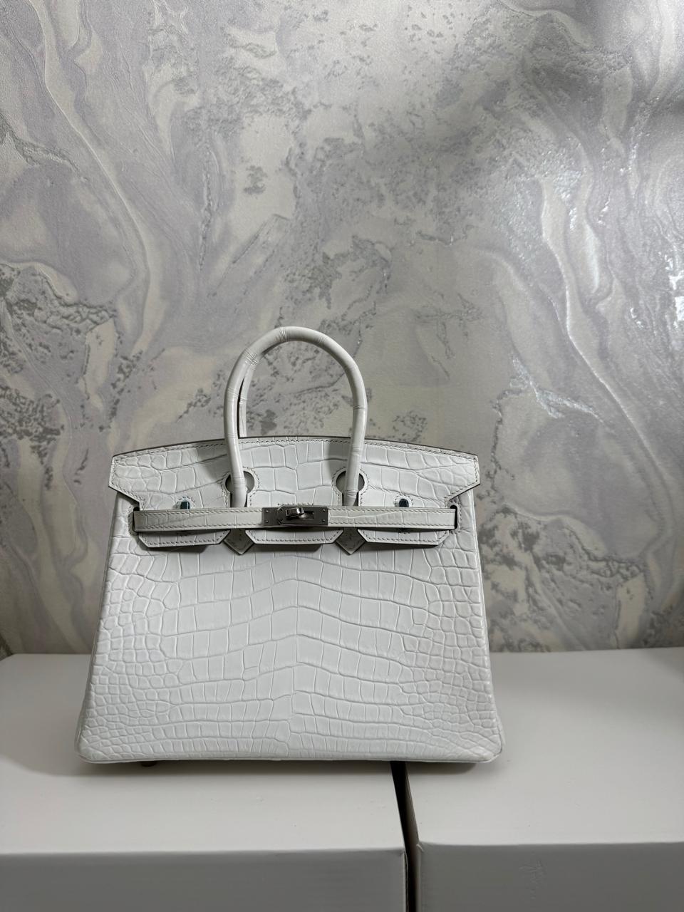 Herm**s crocodile bags.