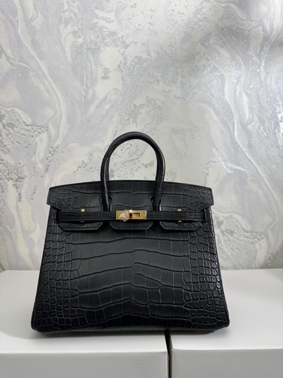 Herm**s crocodile bags.