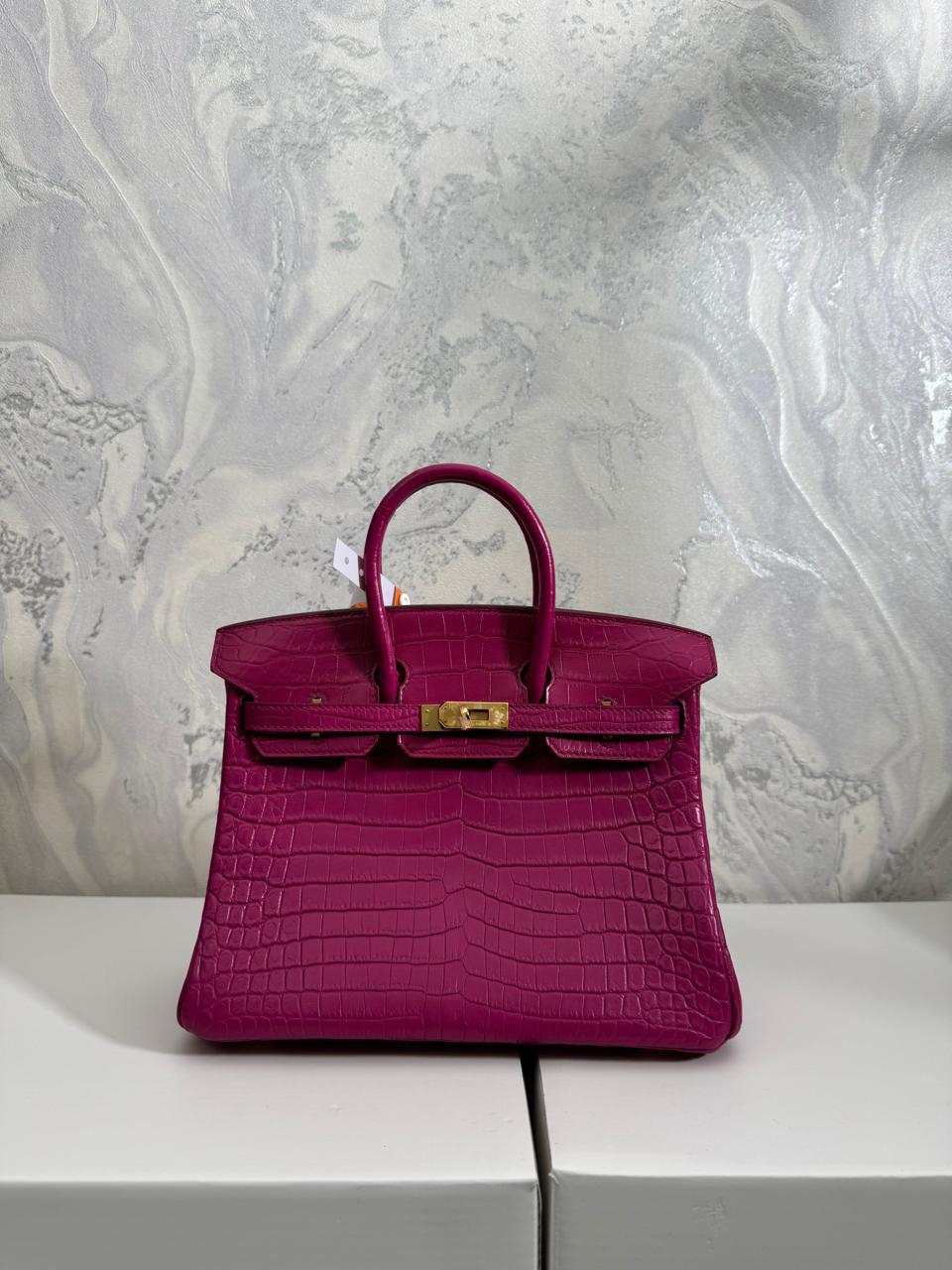 Herm**s crocodile bags.