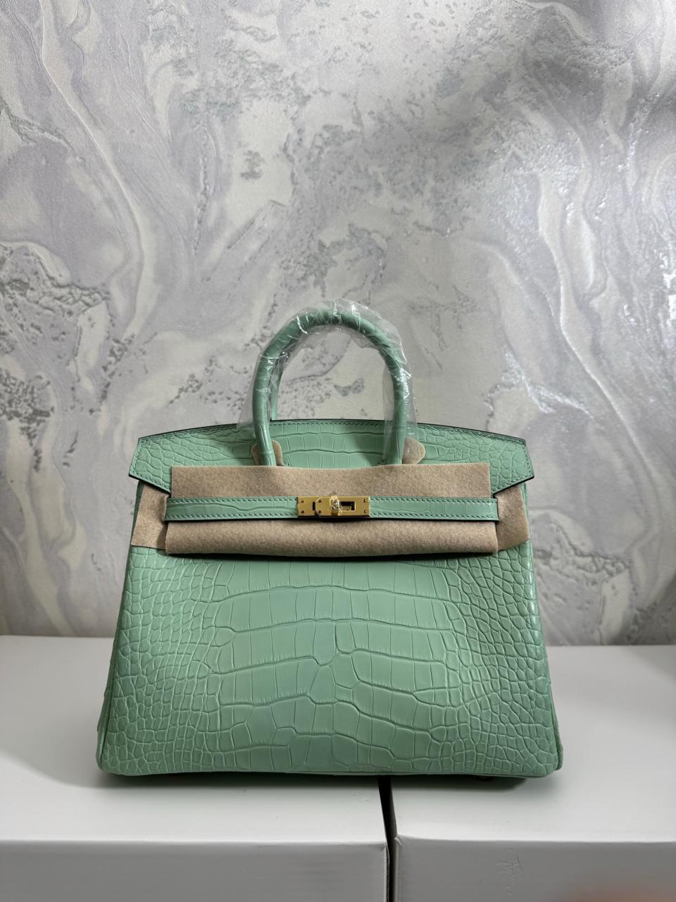 Herm**s crocodile bags.