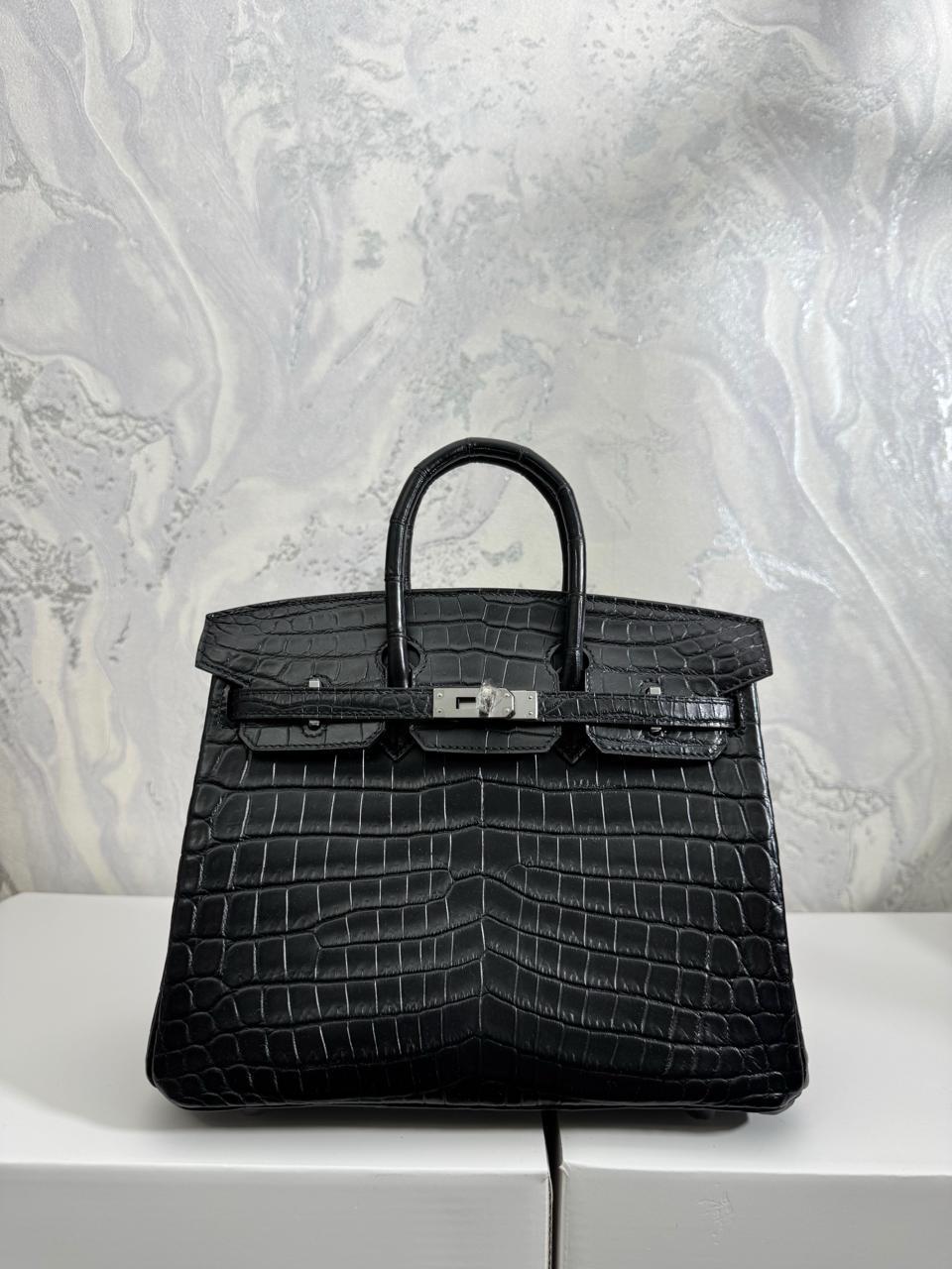 Herm**s crocodile bags.