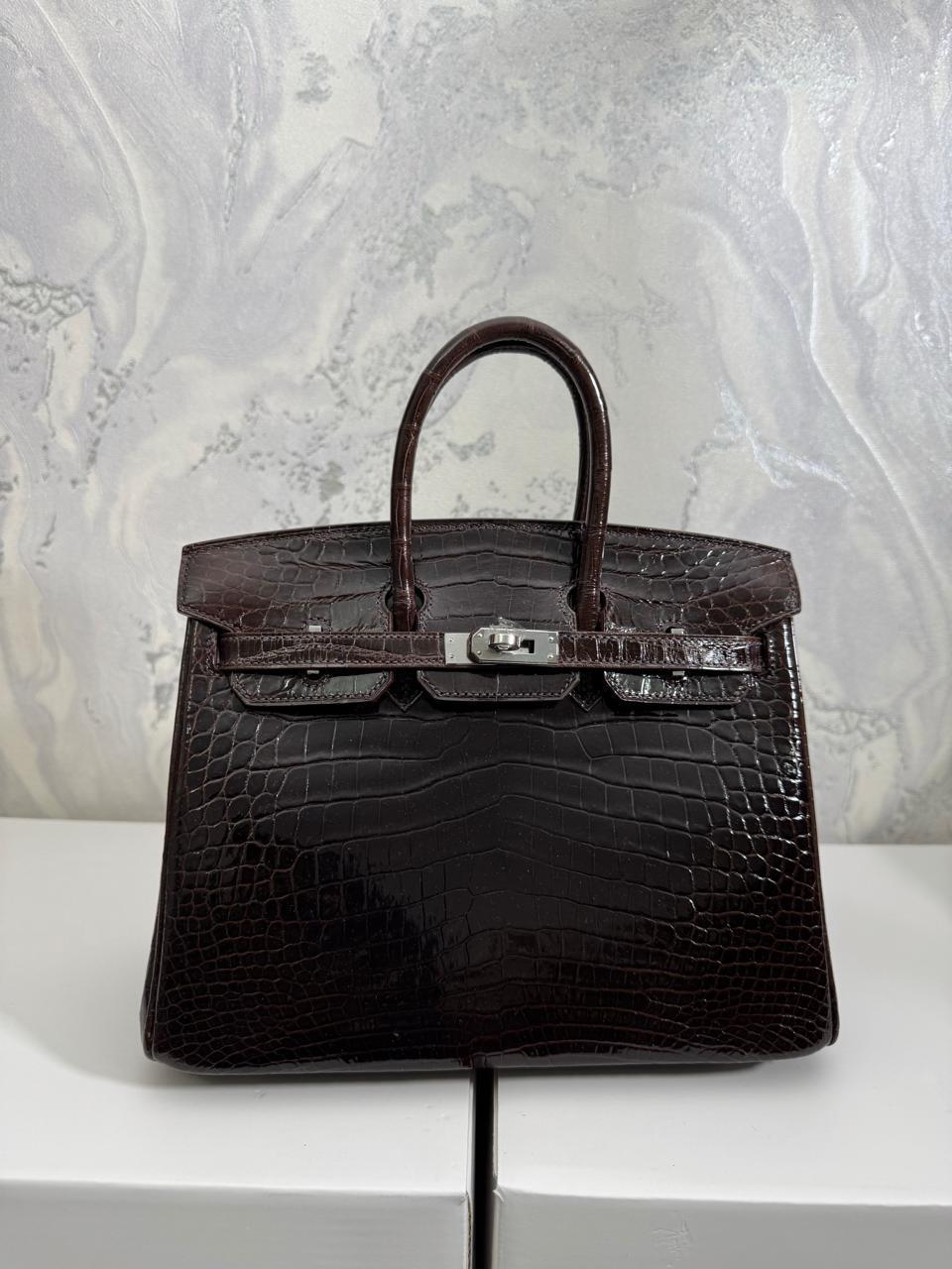 Herm**s crocodile bags.