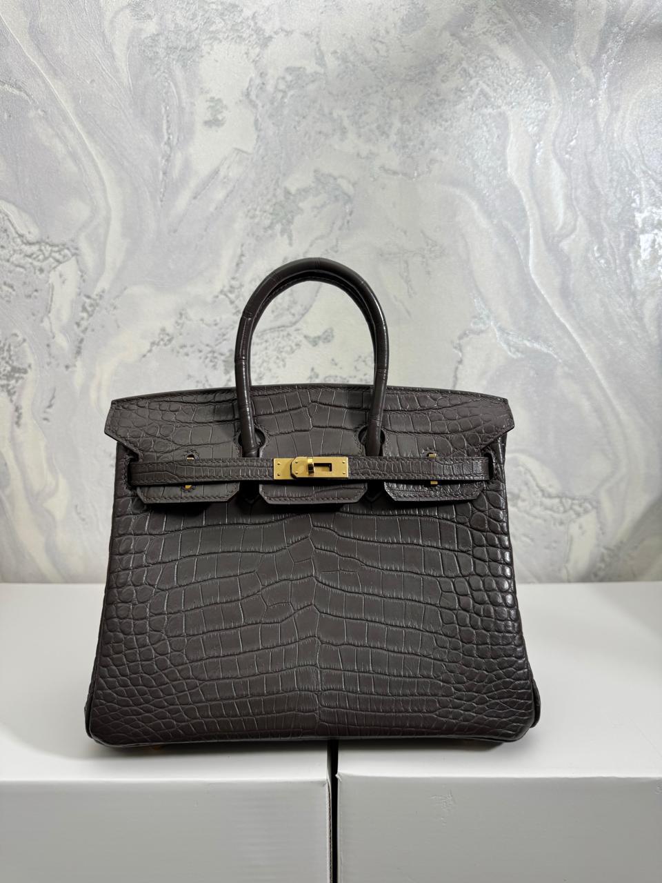 Herm**s crocodile bags.