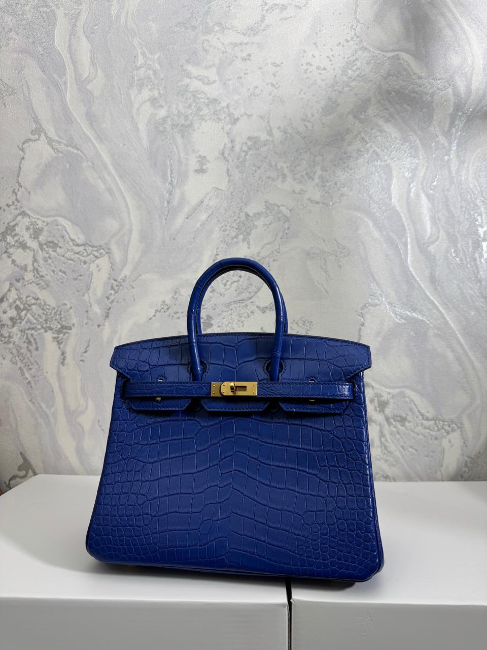 Herm**s crocodile bags.