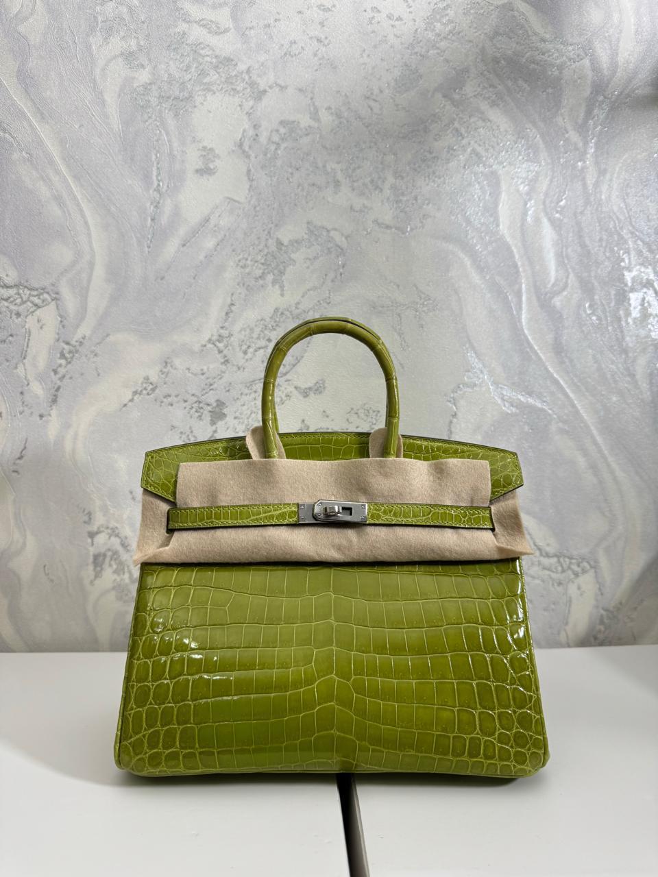 Herm**s crocodile bags.