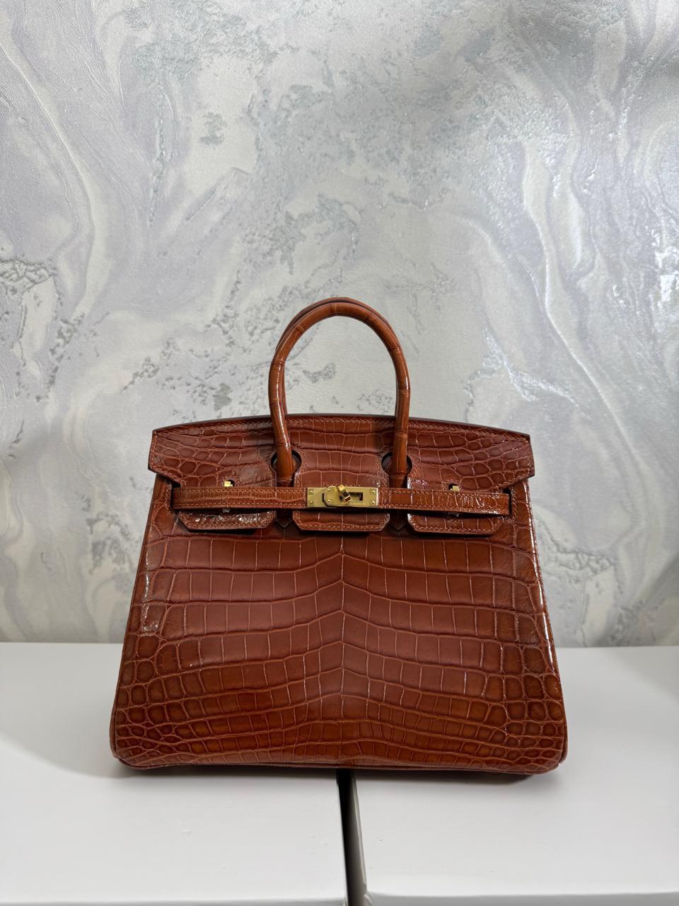 Herm**s crocodile bags.